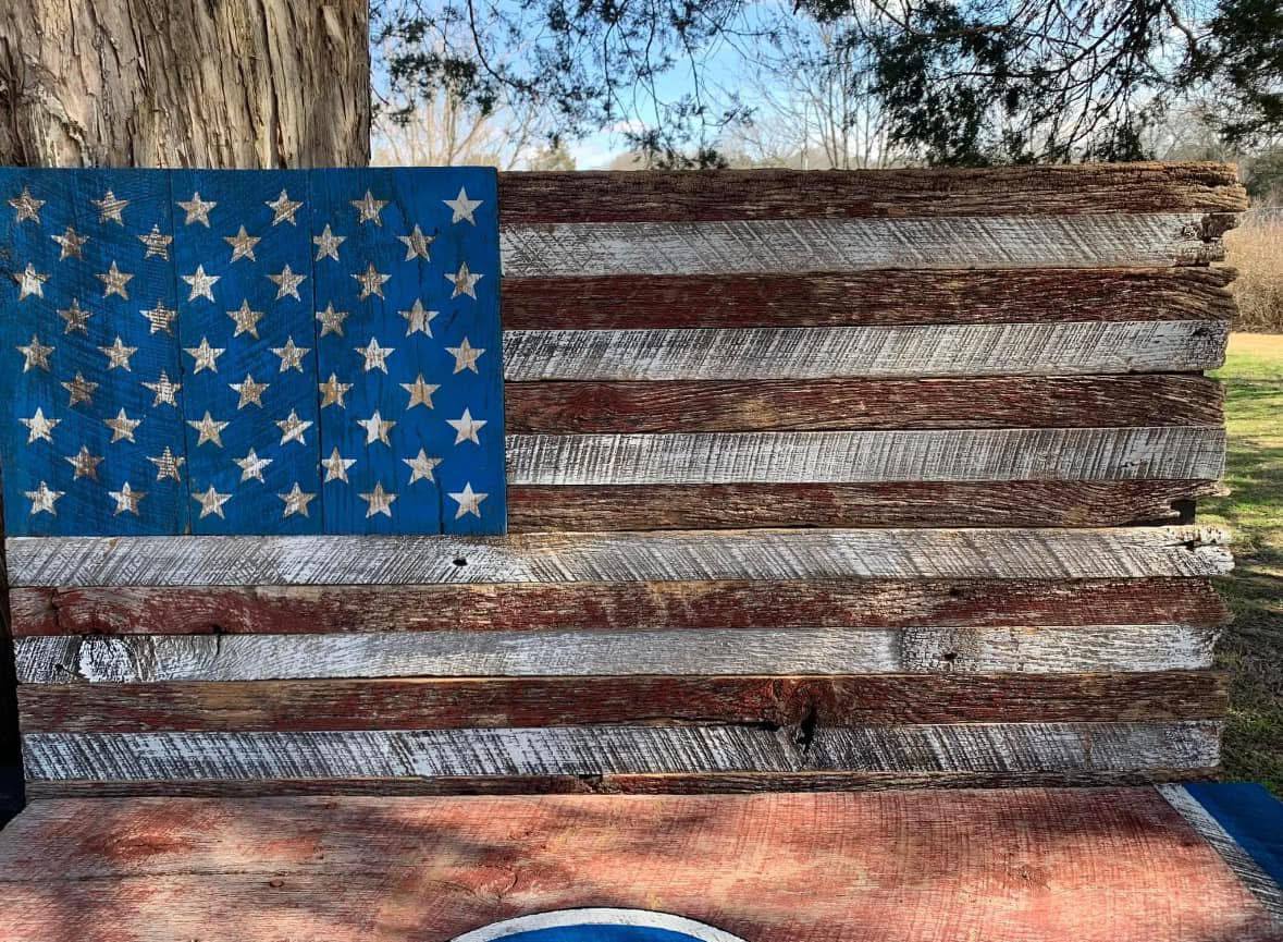 Reclaimed barnwood grain — nail holes, weathering, a century of Tennessee